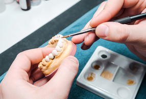 odontotecnico lavora su una protesi